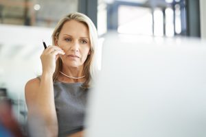 Mature businesswoman using a laptop in a modern office